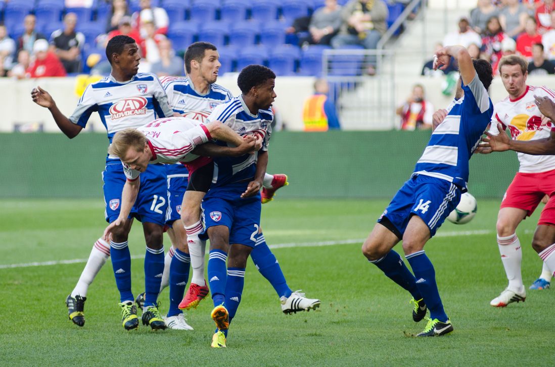 Dax McCarty goes horizontal while attempting to head a ball towards goal.
